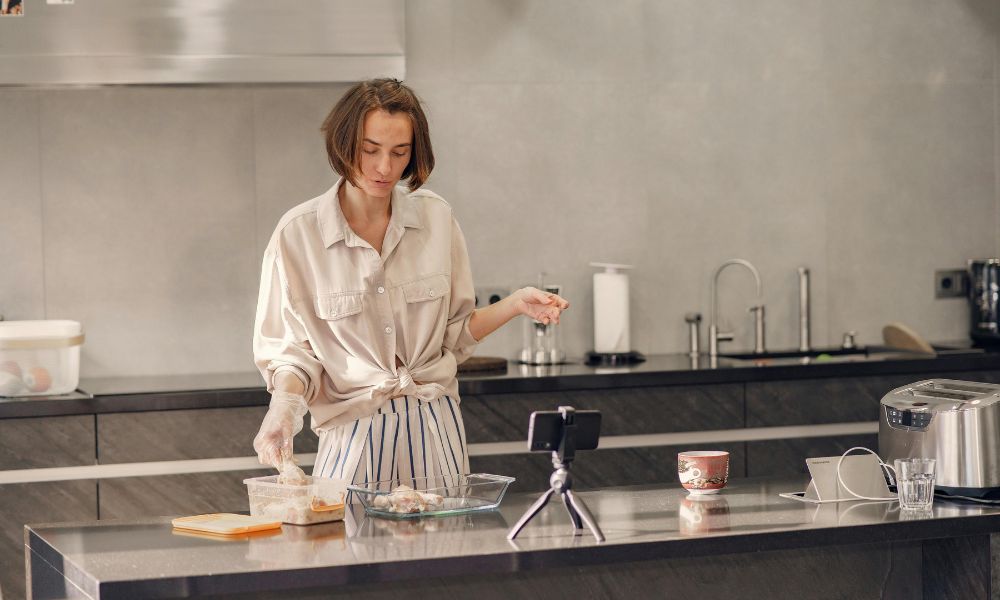 lady filming a cooking video at her kitchen island