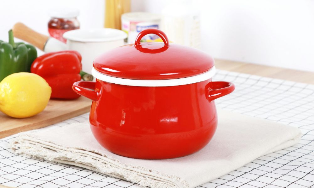 a red hot pot placed a a layer of cloth to prevent thermal shock on the stone countertop