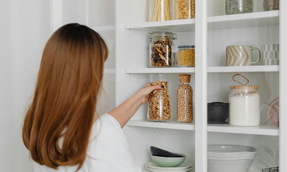 lady organising the kitchen pantry 