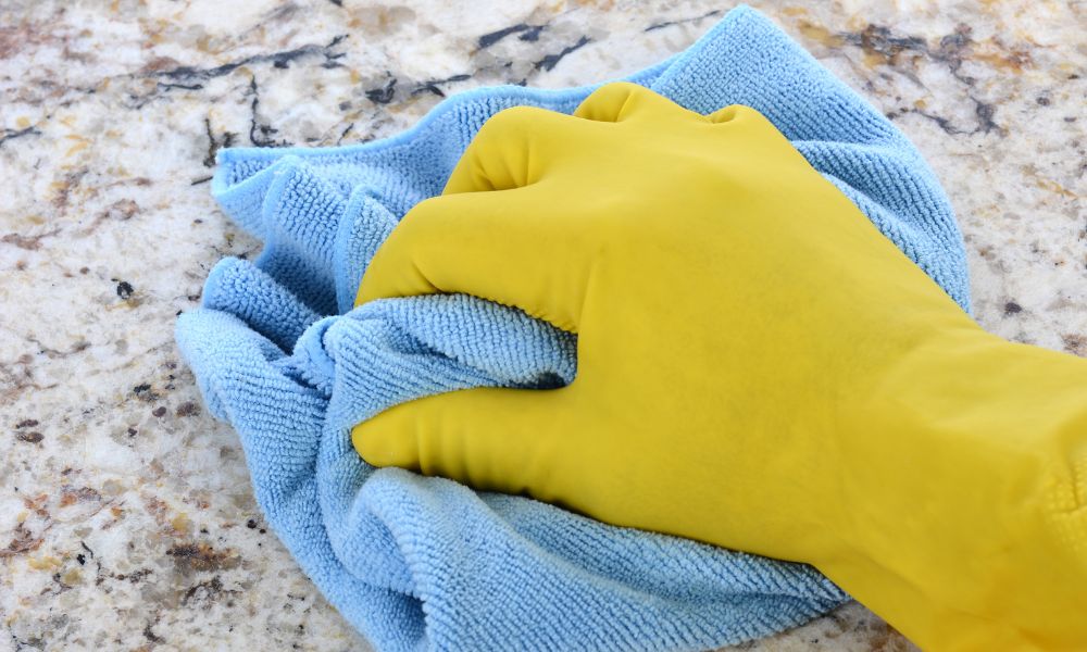 yellow rubber glove microfibre cloth cleaning granite countertop