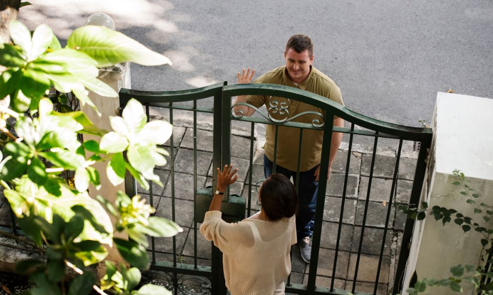 neighbours greeting each other at the gate
