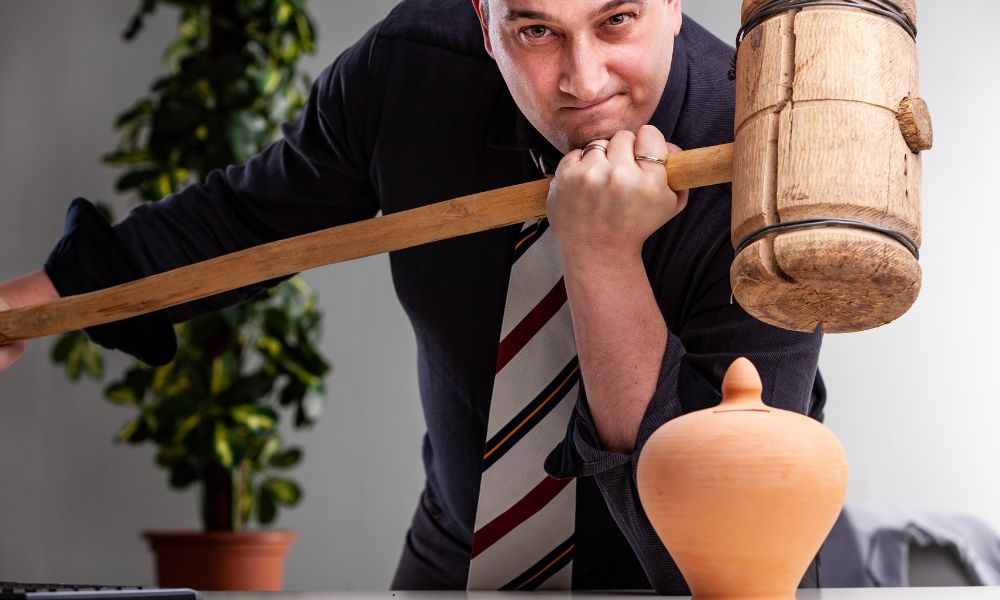 man with hammer testing flexural strenght of countertop