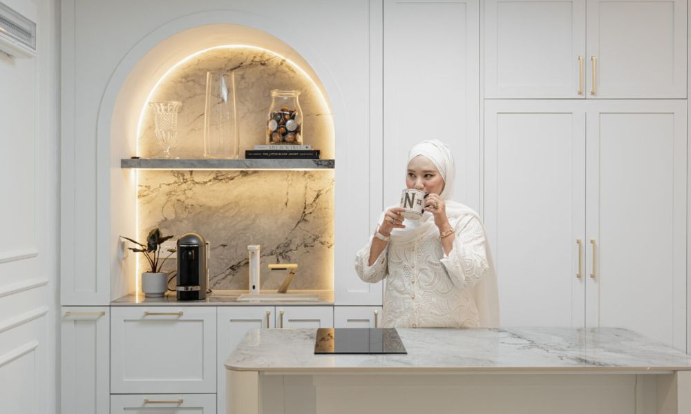 lady drinking tea at her dry kitchen countertop