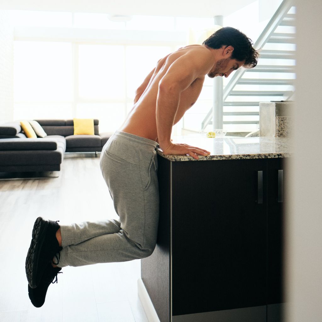 Man doing a push up on the granite countertop